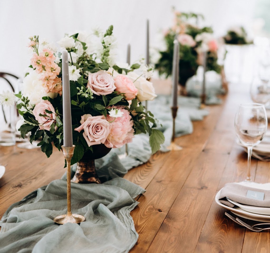 Wooden wedding table decoration with flowers and candles