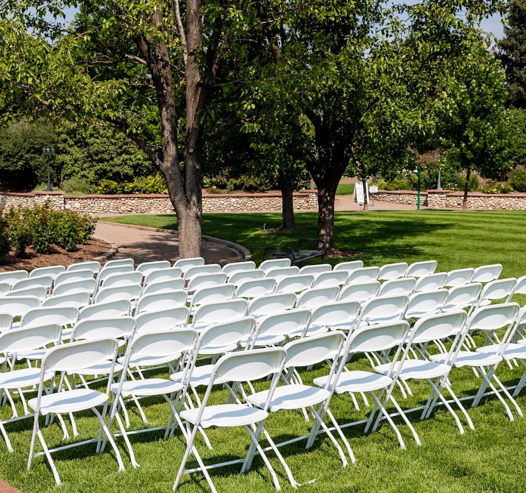 White chairs set up for an outdoor wedding