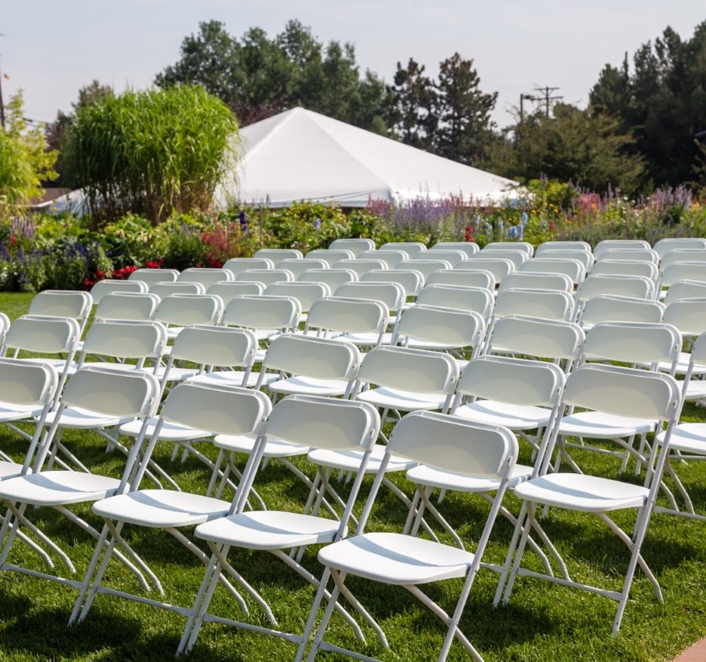 White chairs set up for an outdoor wedding