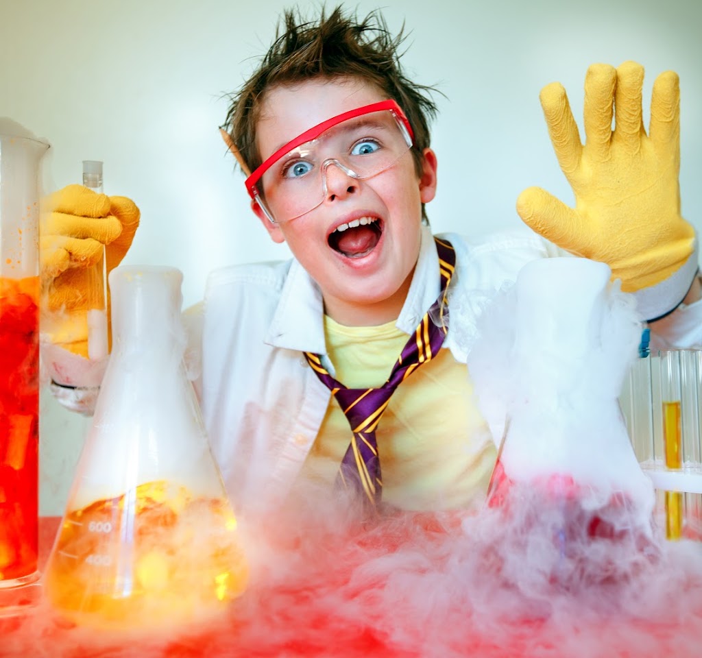 Crazy scientist. Young boy performing experiments; Shutterstock ID 695453308